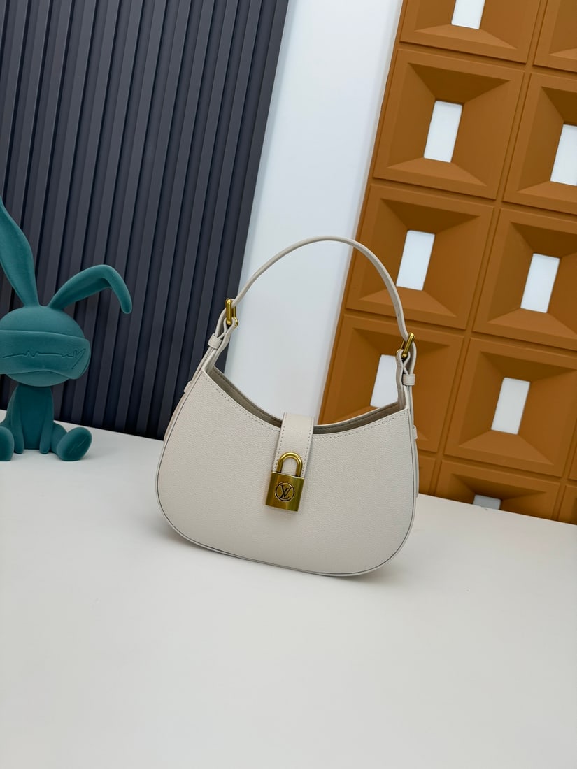 Low Key Shoulder Bag handbag: This Low Key Shoulder Bag is made of soft calfskin leather, features an adjustable shoulder strap and suede lining, and a classic LV padlock. Dimensions: 26 x 18 x 7 cm (Length x Height x Width). We o