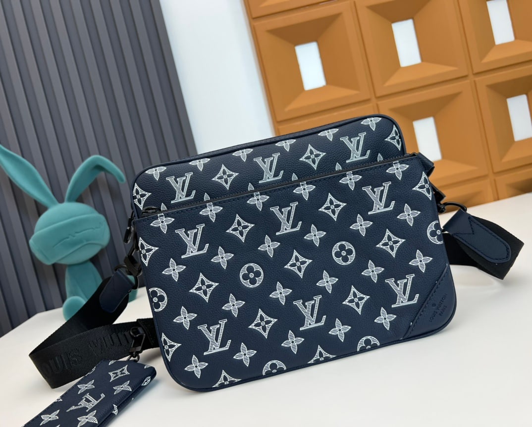 Trio Messenger Bag: This Trio messenger bag is crafted from Monogram Shadow calfskin leather, featuring an embossed and printed Monogram pattern. The coin purse, main compartment, and detachable front pocket can all be