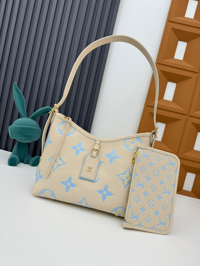CarryAll Small Handbag: The CarryAll small handbag is crafted from Monogram Empreinte embossed leather. It features a Monogram embossed zipper clutch secured with a leather strap. Dimensions: 29 x 24 x 12 cm (Length x