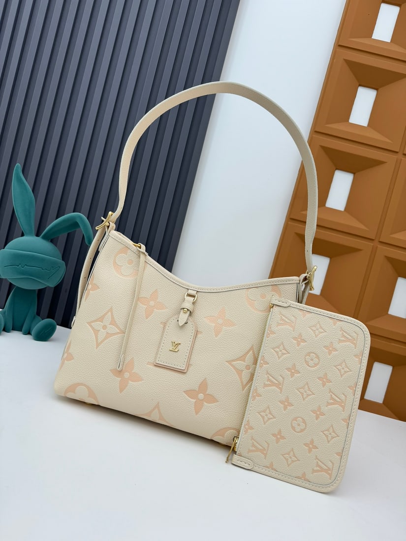 CarryAll Small Handbag: The CarryAll small handbag is crafted from Monogram Empreinte embossed leather. It features a Monogram embossed zipper clutch secured with a leather strap. Dimensions: 29 x 24 x 12 cm (Length x