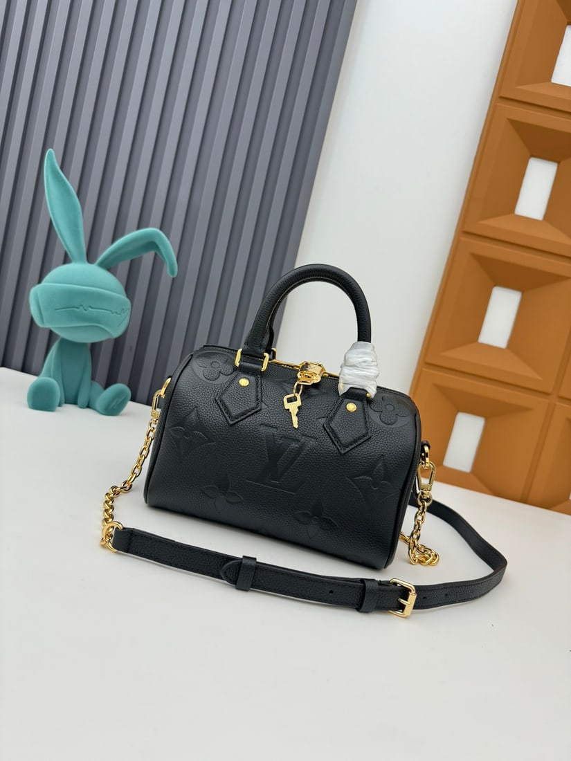 Speedy Bandouliere 20 handbag: Crafted from two tone Monogram Empreinte leather and adorned with the LV logo and Monogram floral pattern, the Speedy Bandouliere 20 handbag is a modern classic. Inspired by the Speedy trunk series of