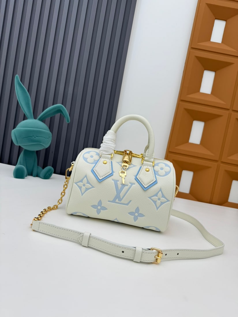 Speedy Bandouliere 20 handbag: Crafted from two tone Monogram Empreinte leather and adorned with the LV logo and Monogram floral pattern, the Speedy Bandouliere 20 handbag is a modern classic. Inspired by the Speedy trunk series of
