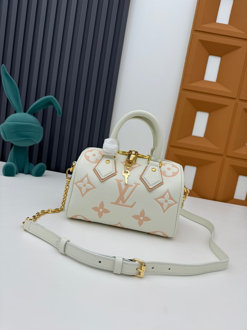 Speedy Bandouliere 20 handbag: Crafted from two tone Monogram Empreinte leather and adorned with the LV logo and Monogram floral pattern, the Speedy Bandouliere 20 handbag is a modern classic. Inspired by the Speedy trunk series of