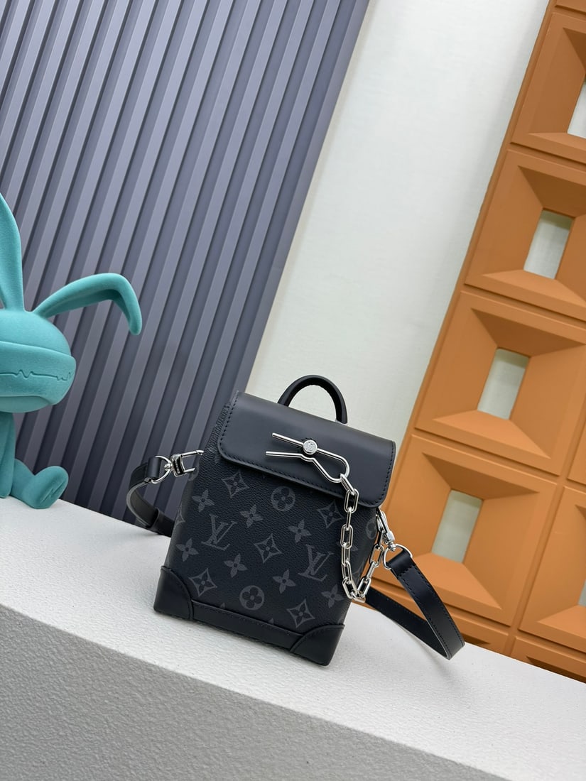 NANO STEAMER handbags: This Nano Steamer handbag is crafted from Monogram Eclipse canvas. It features a top handle and a detachable, adjustable chain, allowing for multiple carrying options. Dimensions: 15 x 18 x 7 cm We