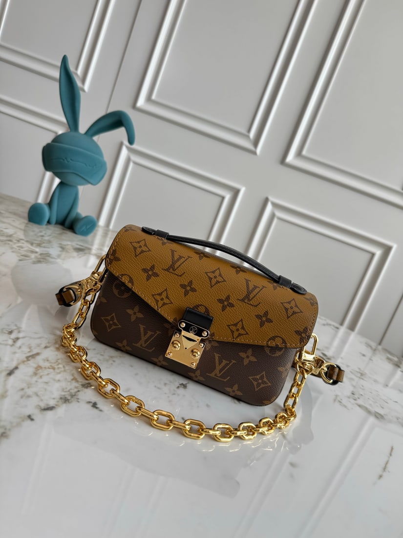 Pochette Metis East West handbag: This Pochette Metis East West handbag features Monogram canvas, cowhide leather trim, and an SXlock clasp, retaining classic elements while incorporating modern details such as a short chain strap for