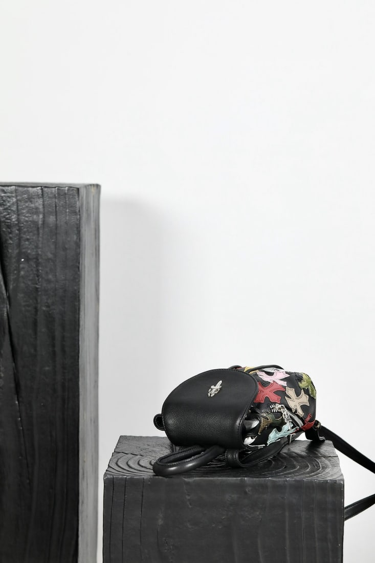 Chrome Hearts Mini Sword Backpack: Chrome Hearts mini sword backpack, model K033 1. Color: Sword patterned leather with colorful sheepskin and black sword jacquard lining. Dimensions: 17x15x8cm. Can be carried on the shoulder or by han