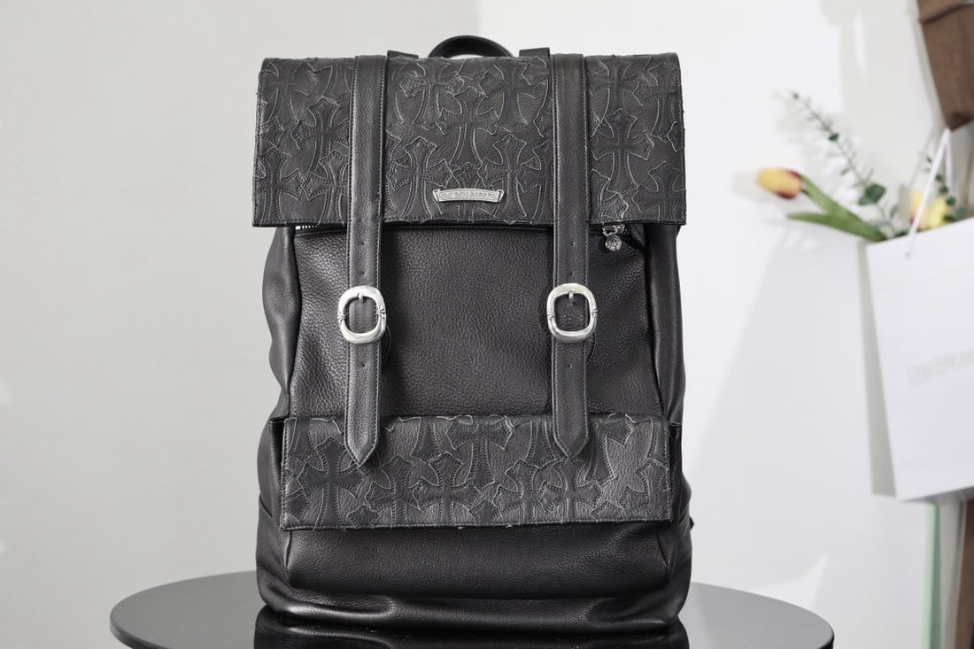 Chrome Hearts Flap Cross Backpack: Chrome Hearts Flap Cross Backpack, silver hardware including 2 half cross square buckles, 2 half cross snap buckles, 2 oval pin buckles, 1 long logo tag, 2 horseshoe shaped studs, 3 large sword zipper