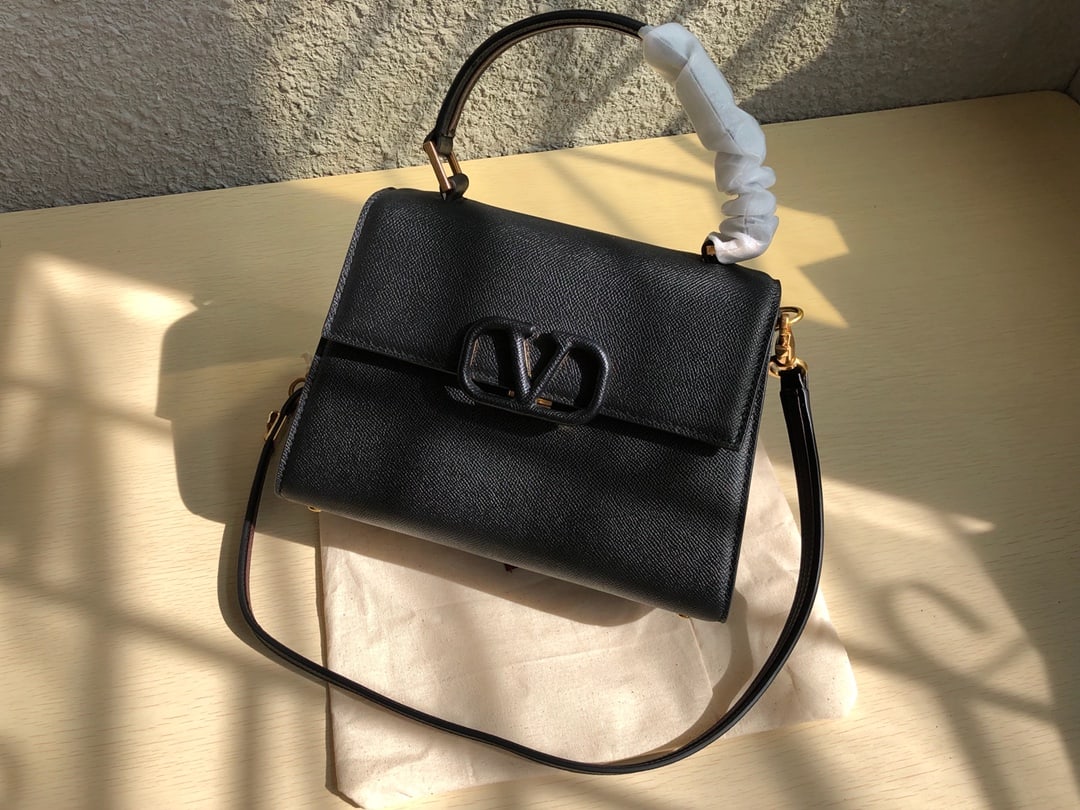 Valentino Garavani VSLING: Valentino Garavani VSLING briefcase with a palm print design. Features an extendable two tone shoulder strap and handles for easy switching between shoulder, crossbody, and hand carry. Vintage finish 