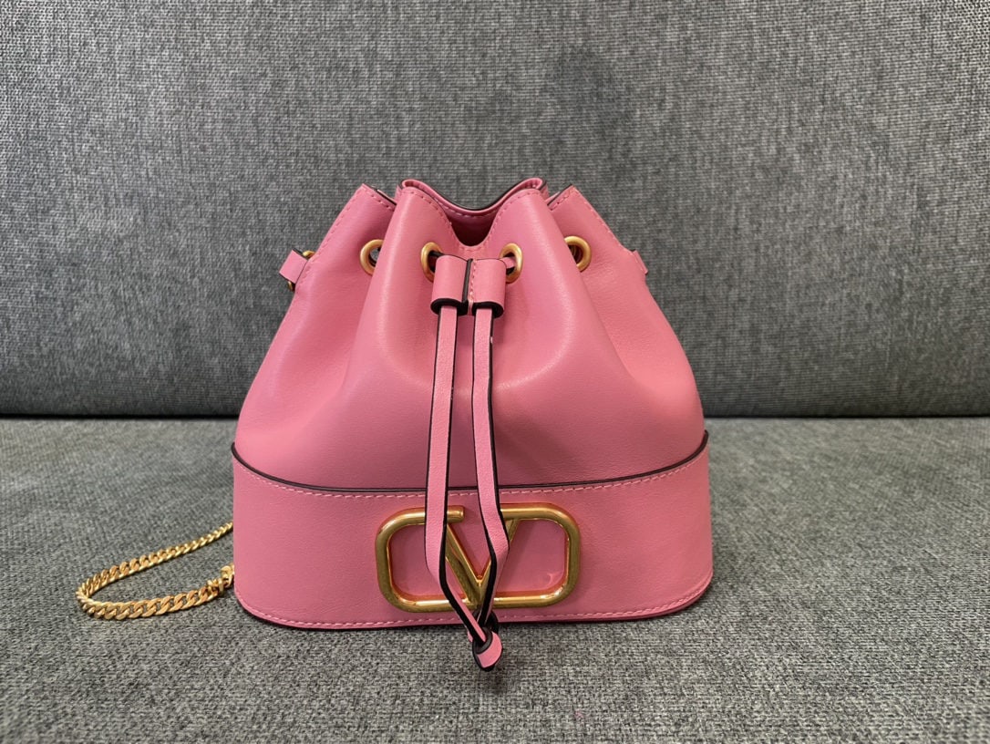 Valentino: Valentino Mini Bucket Bag Valentino Mini Lambskin Bucket Bag Vintage Brass Antique Finish Logo and Hardware Drawstring Closure Chain Shoulder Strap Dimensions: 20cm (W) x 17cm (H) x 8cm (D) We offer F