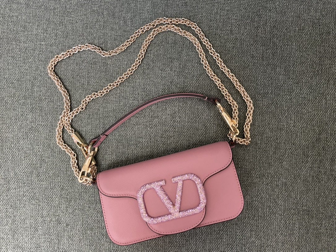 Valentino: Valentino calfskin handbag with star studded buckle, featuring a vintage brass distressed finish, magnetic closure, and soft lambskin lining. We offer FREE SHIPPING for both domestic and international