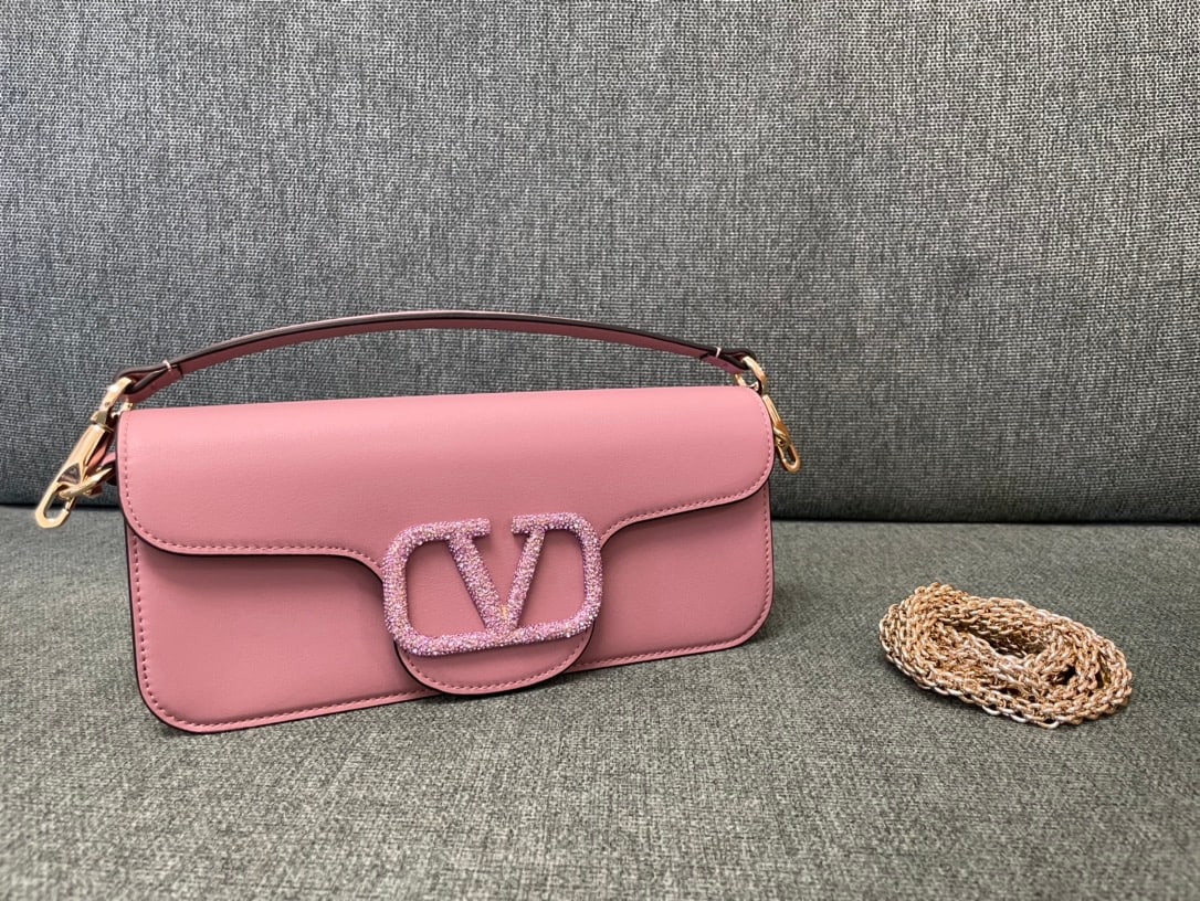 Valentino: Valentino calfskin handbag with star studded buckle, featuring a vintage brass distressed finish, magnetic closure, and soft lambskin lining. We offer FREE SHIPPING for both domestic and international