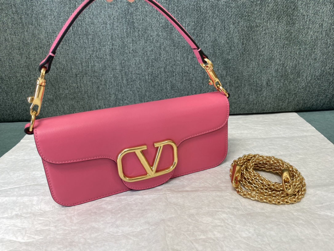 Valentino VLogoSignacar: Valentino calfskin handbag with metal V logo Signacar trim features detachable handles and a detachable sliding chain for shoulder, crossbody, or hand carrying. Vintage brass distressed finish hardwar