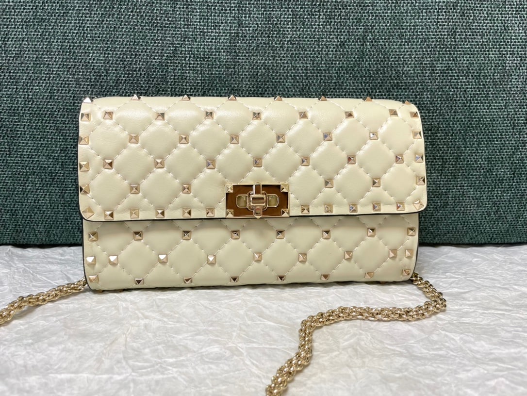 Valentino: Ivory white Valentino studded lambskin shoulder bag/clutch with 8 card slots and one bill compartment. Dimensions: 23.5cm x 14.5cm x 4.5cm We offer FREE SHIPPING for both domestic and international cl