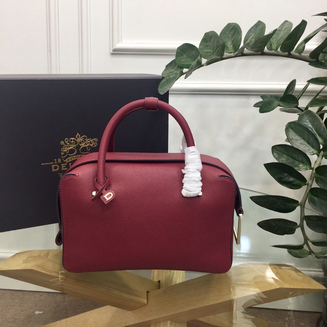 Delvaux: The most striking feature of the Delvau semi handcrafted Cool Box is its unique D shaped pull tab and cubic structure. Unlined, the Cool Box offers ample interior space, is lightweight, and highly fun