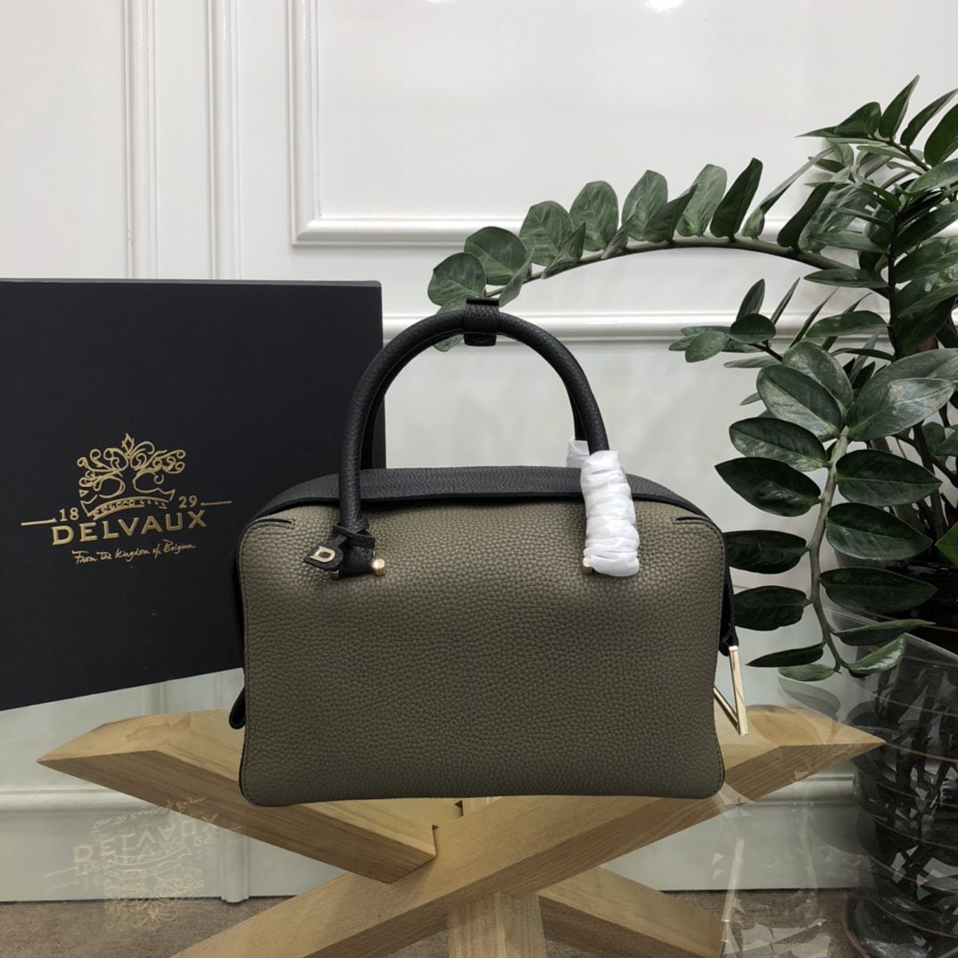 Delvaux: The most striking feature of the Delvau semi handcrafted Cool Box is its unique D shaped pull tab and cubic structure. Unlined, the Cool Box offers ample interior space, is lightweight, and highly fun