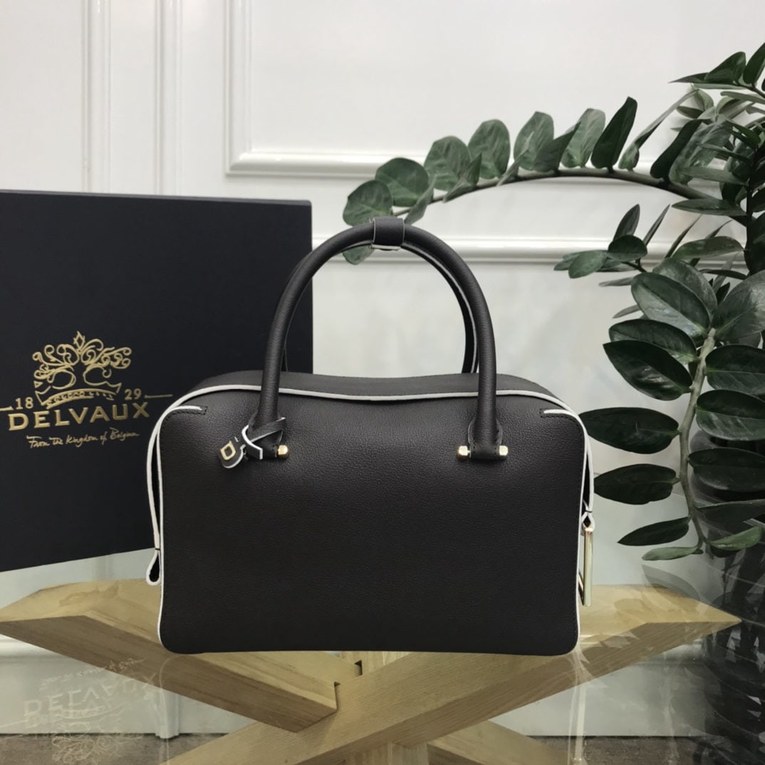 Delvaux: The most striking feature of the Delvau semi handcrafted Cool Box is its unique D shaped pull tab and cubic structure. Unlined, the Cool Box offers ample interior space, is lightweight, and highly