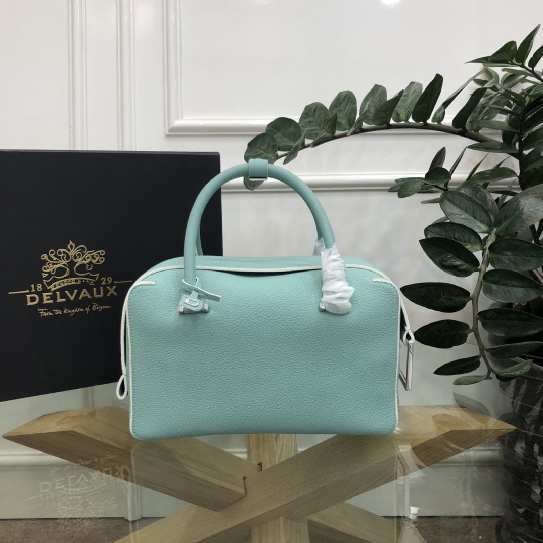 Delvaux: The most striking feature of the Delvau semi handcrafted Cool Box is its unique D shaped pull tab and cubic structure. Unlined, the Cool Box offers ample interior space, is lightweight, and highly fun