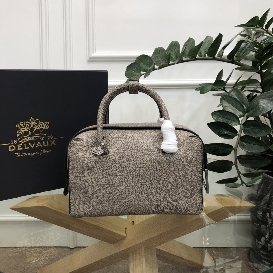Delvaux: The most striking feature of the Delvau semi handcrafted Cool Box is its unique D shaped pull tab and cubic structure. Unlined, the Cool Box offers ample interior space, is lightweight, and highly fun