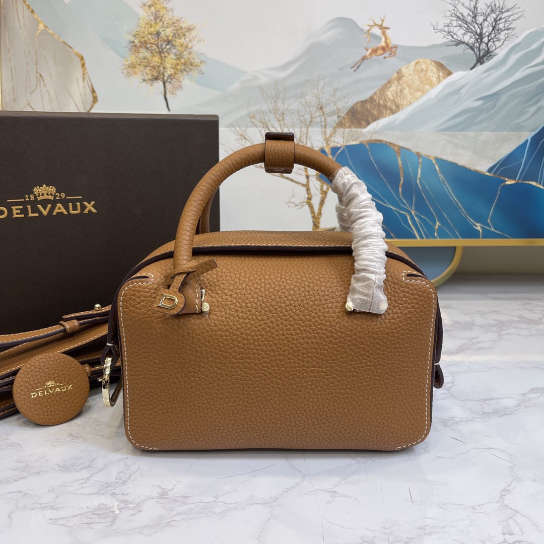 Delvaux: The caramel colored small Cool Box bag is youthful and modern, a trendsetter. Its casual, lightweight, and comfortable design embodies a unique spirit, combining beauty and practicality. The Cool Box 