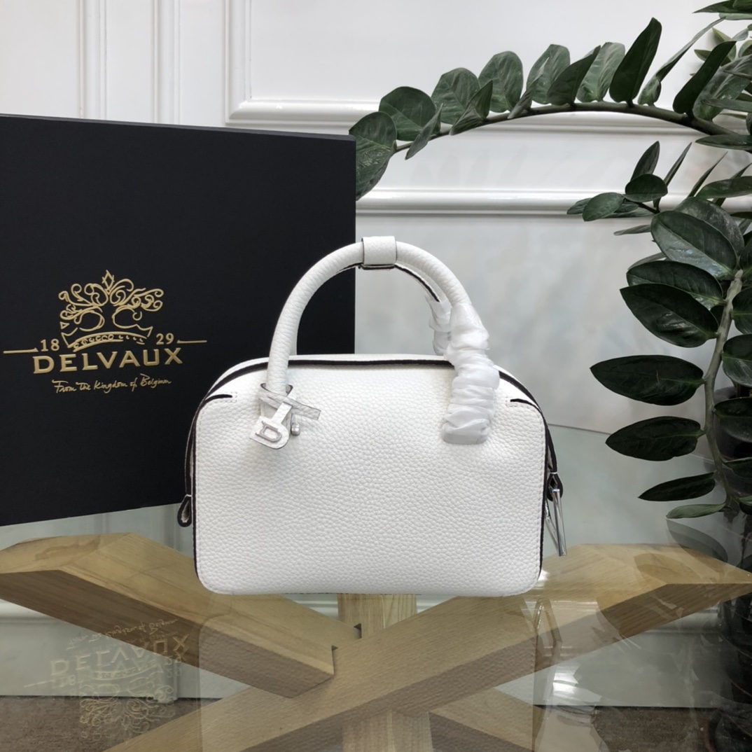 Delvaux: The small black and white Cool Box bag is youthful and modern, a trendsetter. Its casual, lightweight, and comfortable design embodies a unique spirit, combining aesthetics and practicality. The Cool 