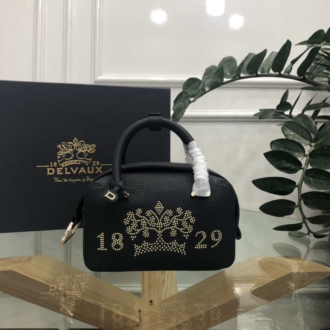 Delvaux: The black crown print small Cool Box bag is youthful and modern, a trendsetter. Its casual, lightweight, and comfortable design embodies a unique spirit, combining beauty and practicality. The Cool Bo