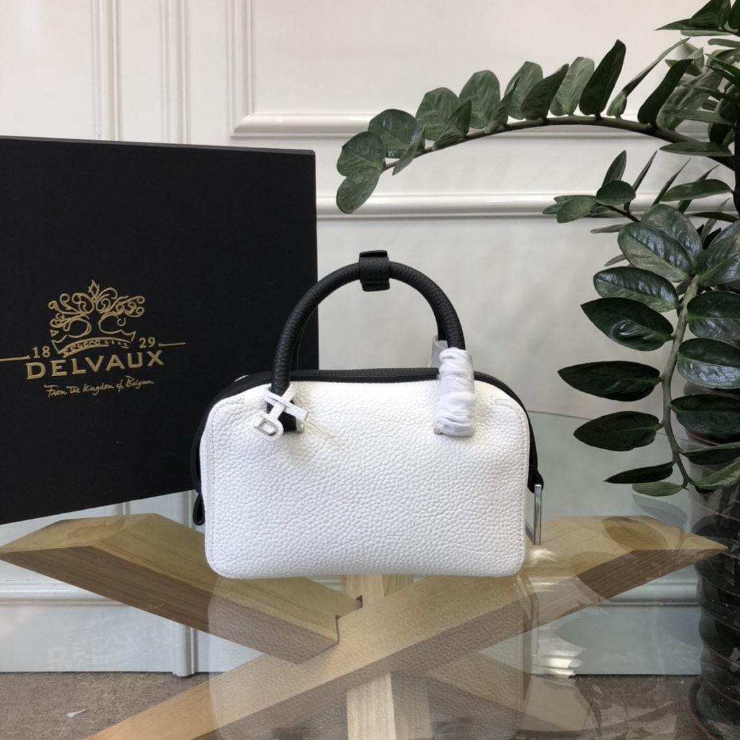 Delvaux: The white and black Cool Box Mini is youthful and modern, a trendsetter. Its casual, lightweight, and comfortable design embodies a unique spirit, combining beauty and practicality. Perfect for carryi