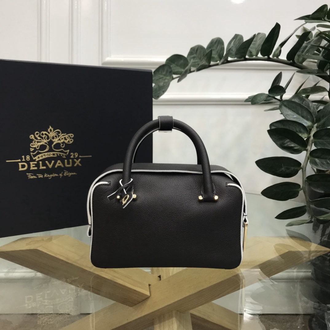 Delvaux: The Ebony Black Small Cool Box is youthful and modern, a trendsetter of the times. Its casual, lightweight, and comfortable design embodies a unique spirit, combining beauty and practicality. The Cool