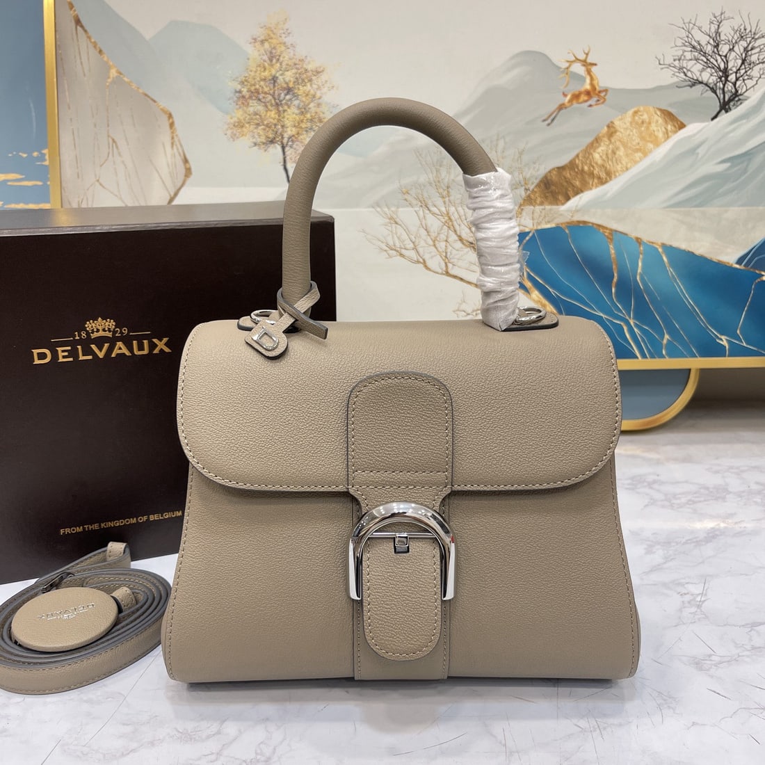 Delvaux: New PM togo leather, milky gray, Belgian Delvaux Brillant classic redesign! Adorned with select Rodeo Calf grain calfskin, the Brillant PM bag stands out for its clean leather cut and elegant, flowing
