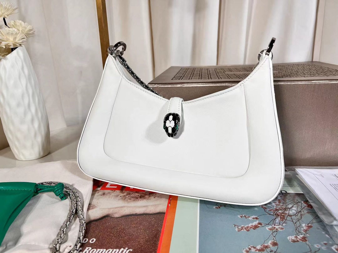 Bvlgari SERPENTI BAIA: The Bvlgari SERPENTI BAIA small shoulder bag is crafted from supple and durable diamond white calfskin. The adjustable shoulder strap is adorned with the iconic snakehead magnetic clasp and alluring s