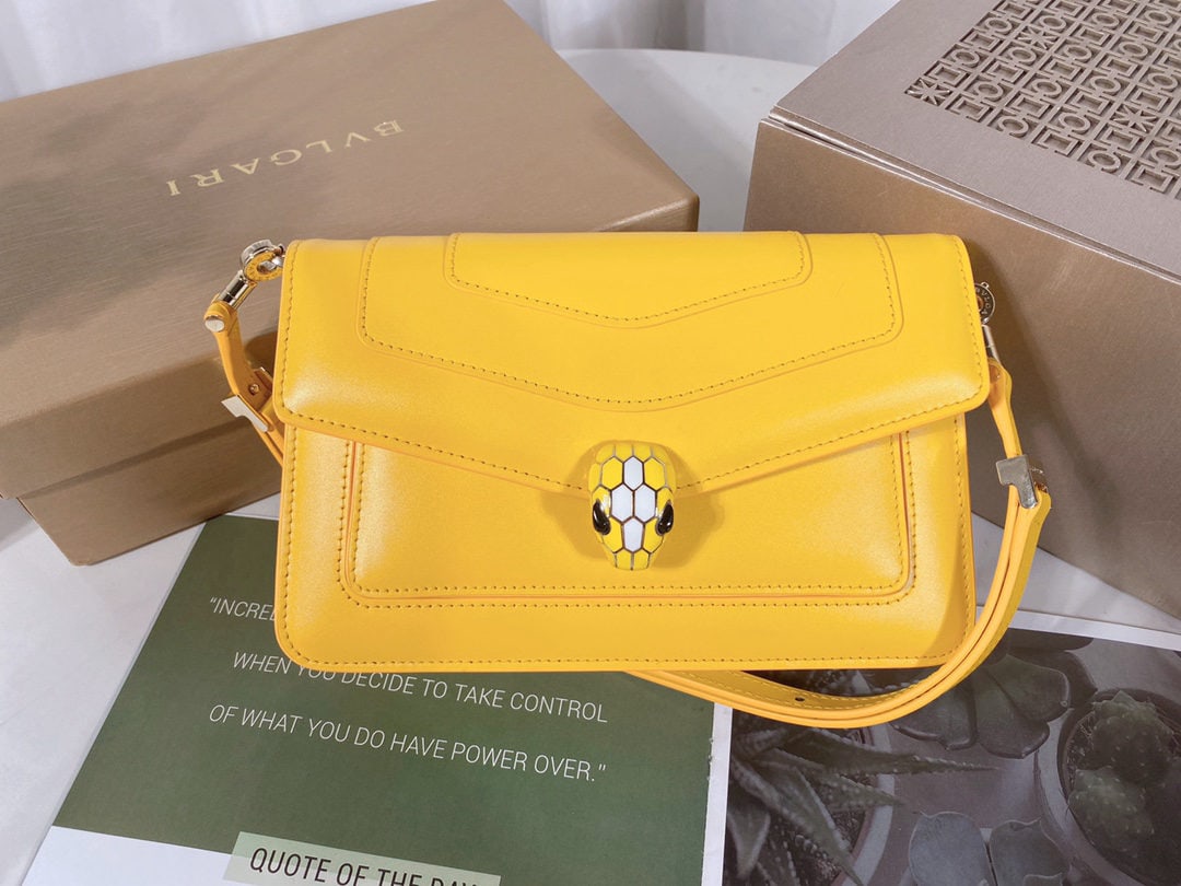 Bvlgari SERPENTI FOREVER EAST WEST: SERPENTI FOREVER EAST WEST Small Shoulder Bag is crafted from daisy topaz colored calfskin. The bag features a practical leather shoulder strap adorned with a classic snakesnake head magnetic closure,