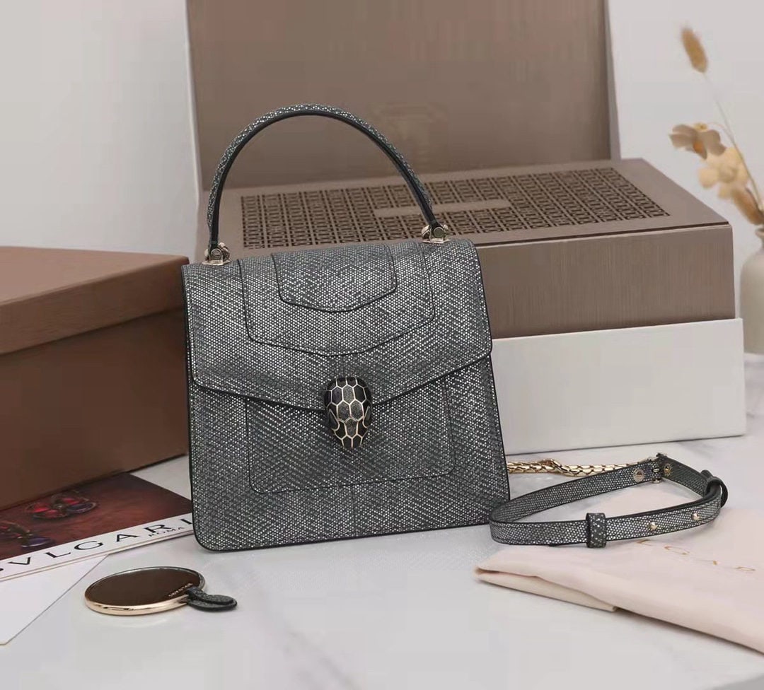 Bvlgari SERPENTI FOREVER: The Bvlgari SERPENTI FOREVER collection is crafted from precious charcoal black diamond colored metallic calfskin. The shimmering charcoal black diamond and glossy black enamel scales, paired with bla