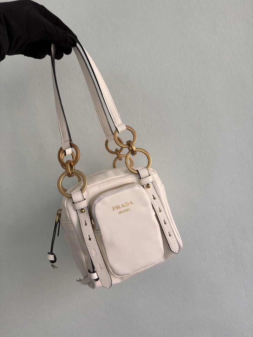 PRADA shoulder bag: This new square shaped tote bag is crafted from premium, soft, oil waxed leather with a vintage feel. Vintage metal hardware and a classic zippered pocket exude retro charm. It boasts a spacious inter