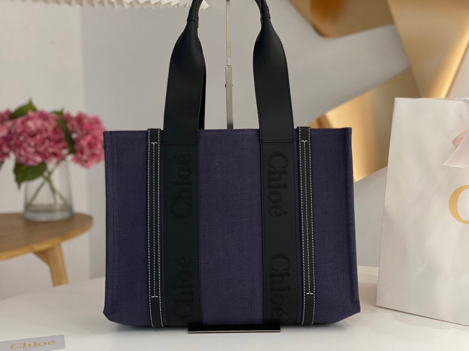 Chloe: Chloe's navy blue and black Woody tote bag, a new early spring release. Understated luxury and sophisticated design, this handbag is truly beautiful and unisex. We offer FREE SHIPPING for both domesti