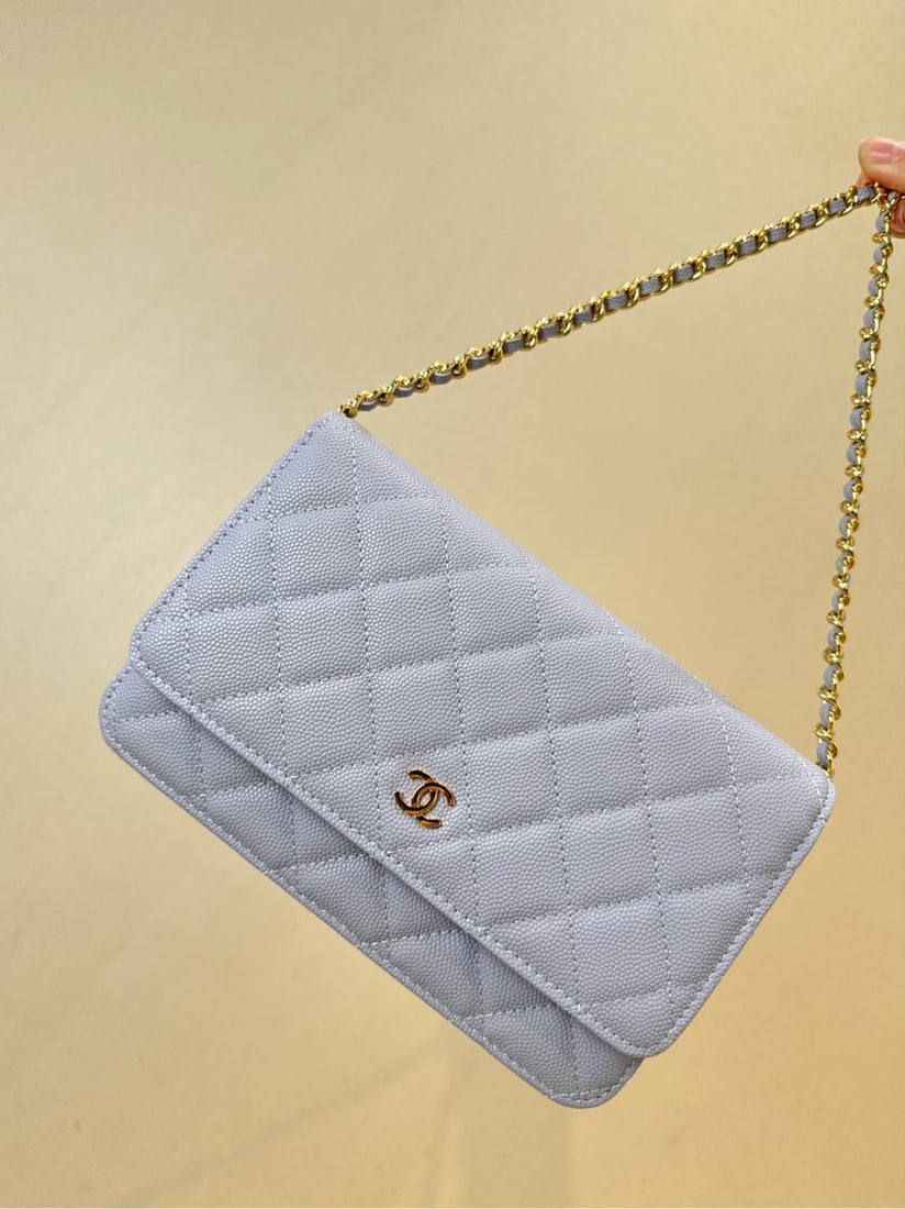 CHANEL: This quilted chain bag exudes elegance with a cool, classic shape. Its square frame and size make it suitable for all everyday styles. Made from caviar calfskin, it boasts a beautiful sheen in