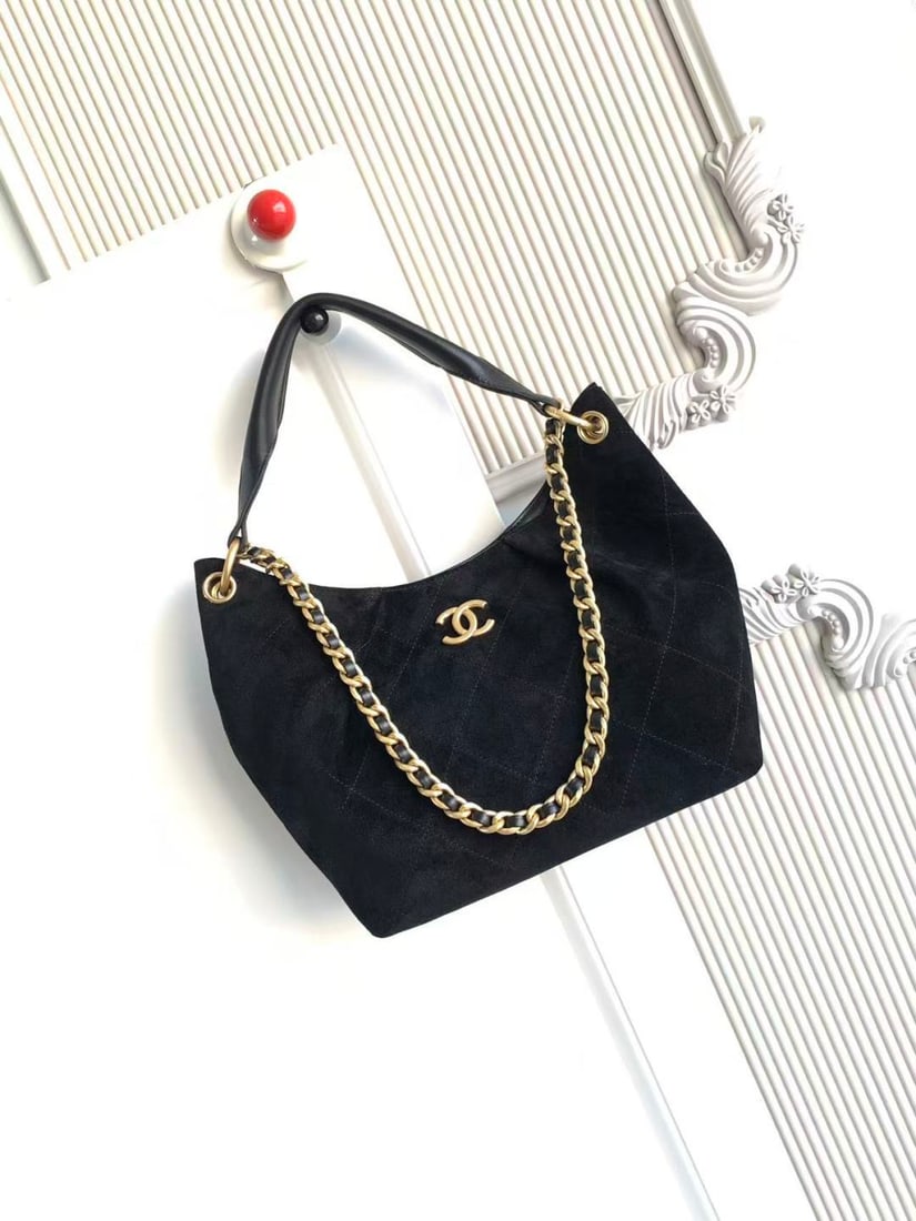 CHANEL Early Spring Collection Hobo Hippie Bag: CHANEL's early spring collection hobo bag features a delicate, short pile texture that is soft and skin friendly. The vintage gold tone metal chain adds a touch of retro elegance, while the matching c