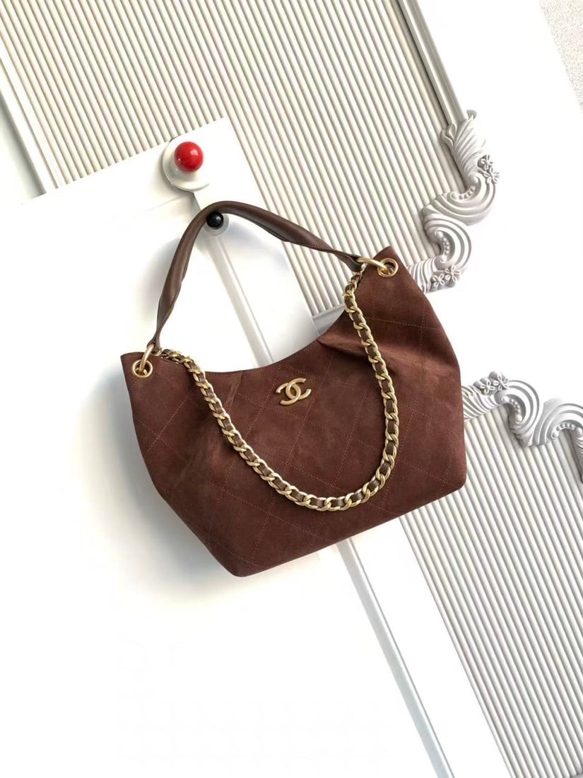 CHANEL Early Spring Collection Hobo Hippie Bag: CHANEL's early spring collection hobo bag features a delicate, short pile texture that is soft and skin friendly. The vintage gold tone metal chain adds a touch of retro elegance, while the matching c