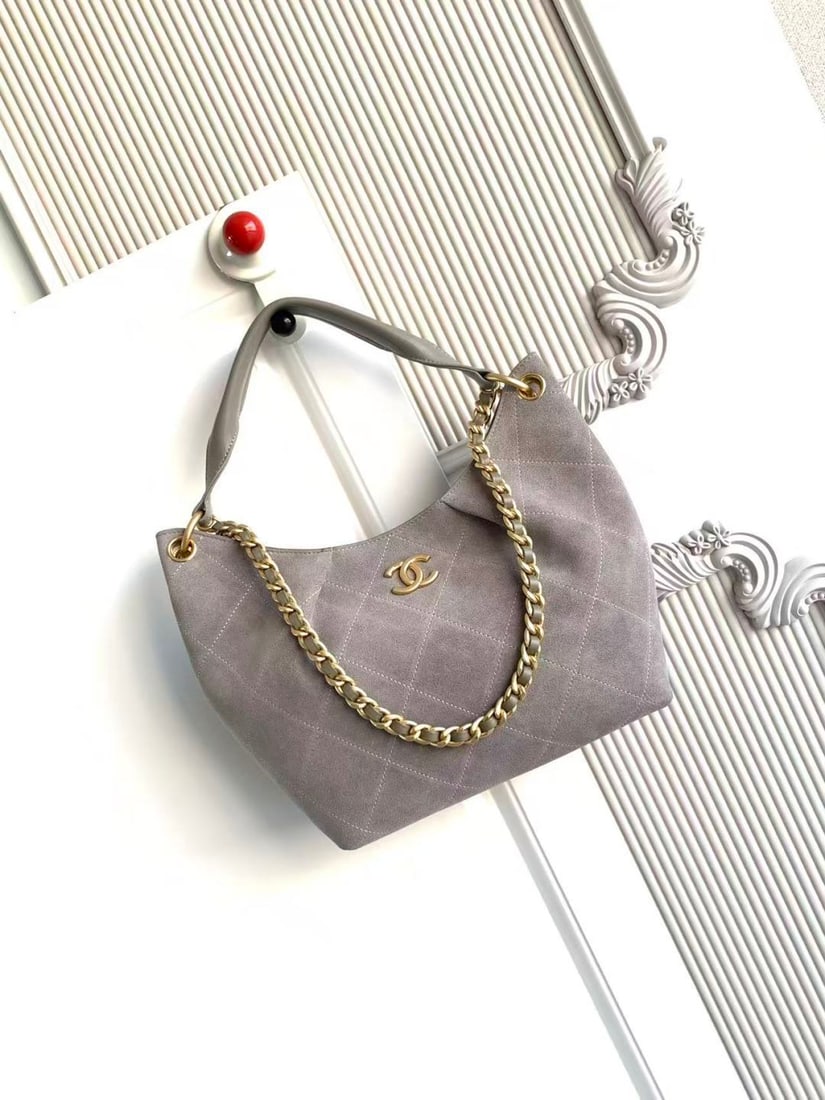 CHANEL Early Spring Collection Hobo Hippie Bag: CHANEL's early spring collection hobo bag features a delicate, short pile texture that is soft and skin friendly. The vintage gold tone metal chain adds a touch of retro elegance, while the matching c