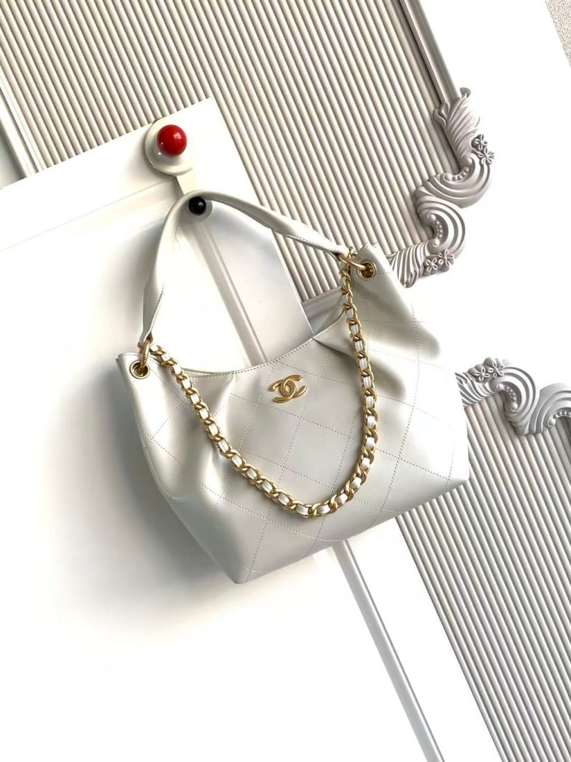 CHANEL Early Spring Collection Hobo Hippie Bag: CHANEL's early spring collection hobo bag features a delicate, short pile texture that is soft and skin friendly. The vintage gold tone metal chain adds a touch of retro elegance, while the matching c