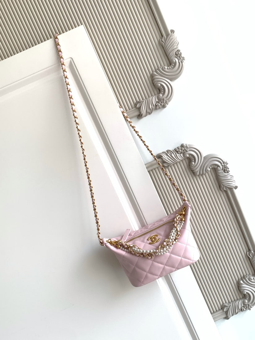 CHANEL Pearl Chain Lunch Box Bag: This pearl chain lunchbox bag features a classic quilted pattern, made of lambskin with a vintage metal chain adorned with pearls. The hobo shape offers moderate capacity, easily holding a phone and l