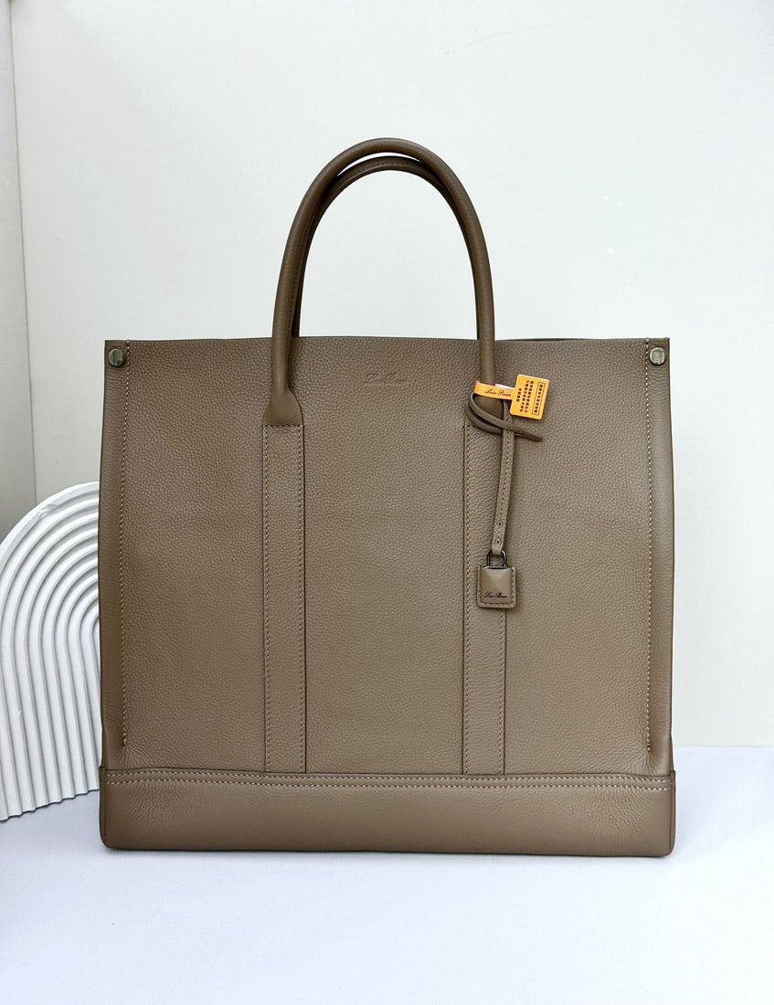 Loro Piana Beam Small Tote Bag: The Loro Piana Beam Small Tote Bag in dark brown pays homage to Loro Piana's rich textile tradition by being named after the "beam," an important component of the loom. Its retractable base, inspired