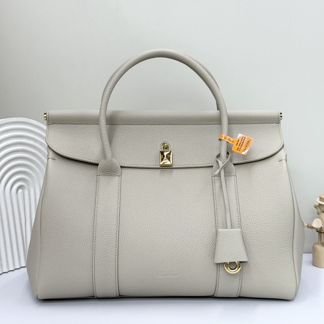 Loro piana Loro piana Loom L32 Handbag: The Loro Piana Loom L32 tote bag is crafted from premium calfskin with a suede lining, offering a unique and lightweight feel. It features a delicate padlock that can be opened, exuding a casual style