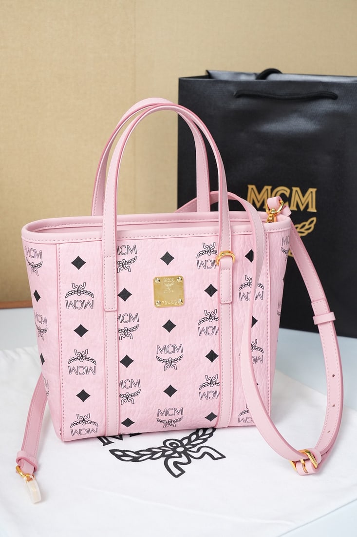 mcm tini visetos mini peach blossom pink shopping bag/basket: MCM Tini Visetos Mini Peach Blossom Pink Shopping Bag/Basket Bag. A classic peach blossom pink monogram print bag that can be worn on the shoulder or crossbody. Perfect for everyday wear, versatile, f