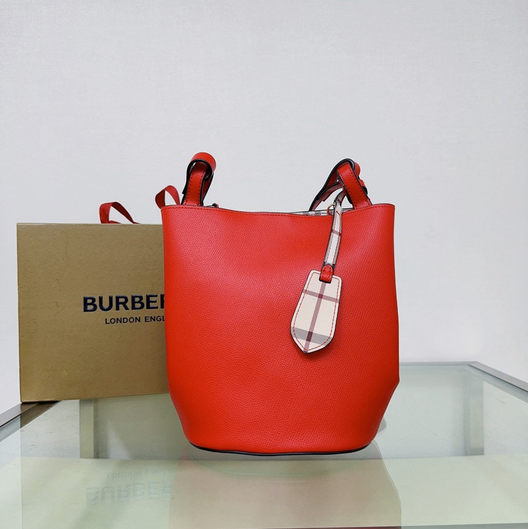 Burberry: This minimalist Burberry crossbody bucket bag is crafted from lightweight, hand-grained leather by master artisans in Italy and features the classic Haymarket check pattern. Its compact design makes i