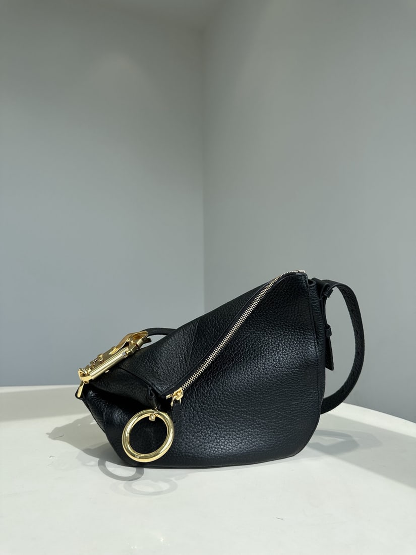 Burberry: The Burberry Knight shoulder bag is inspired by the Equestrian Knight emblem (EKD). Crafted from custom Italian pebbled calfskin, the leather is soft, lustrous, and features a clear grain, offering