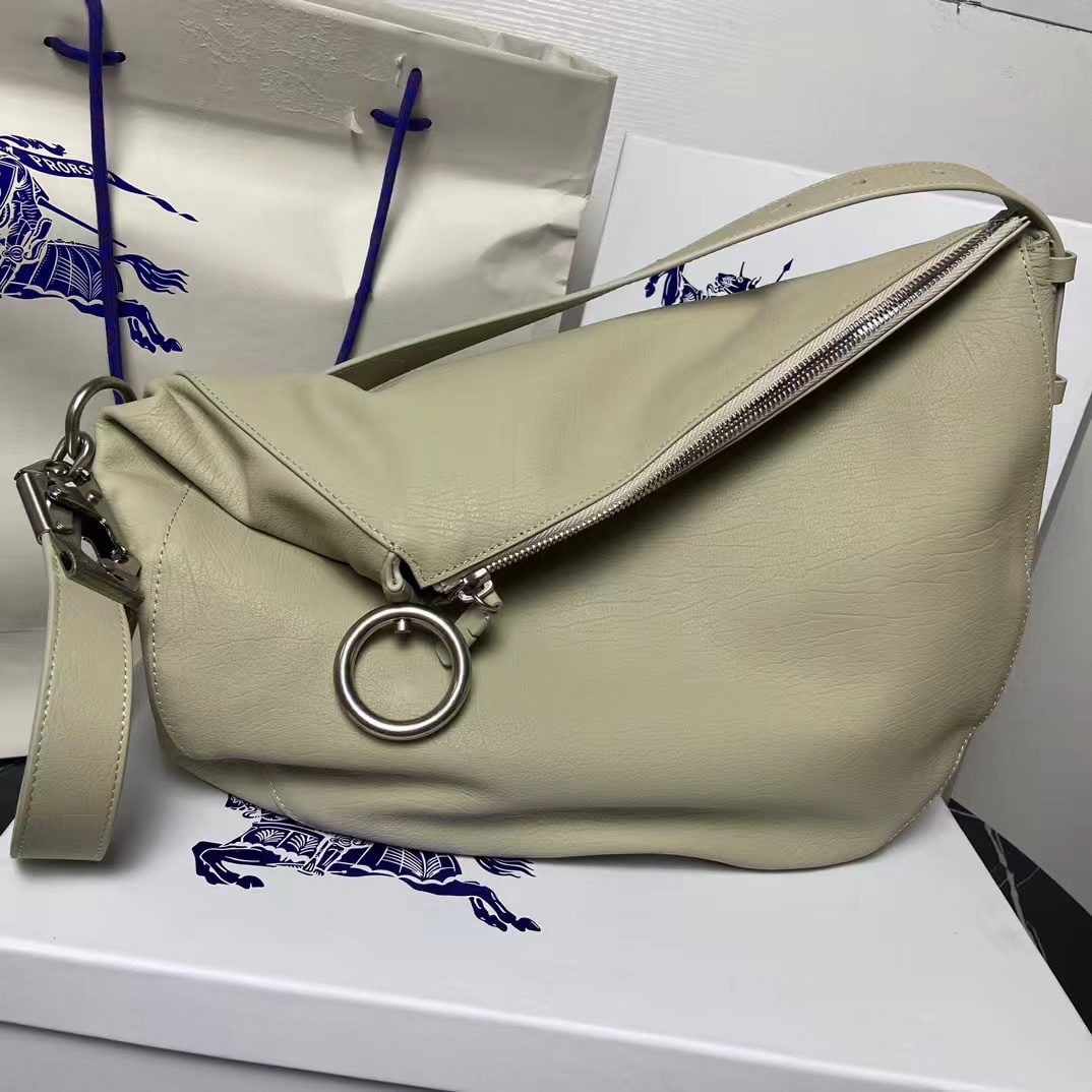 Burberry Knight: This medium-sized Knight bag is crafted from natural grain calfskin leather in Italian workshops, featuring a soft yet structured design. It includes a hook-and-loop closure that playfully incorporate
