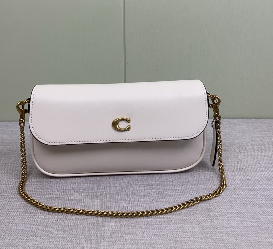 COACH: COACH's February Brook Chain bag is a lightweight and stylish baguette bag. It's a practical small bag with a flap design for added privacy, and an interior zippered compartment. The metal chain and