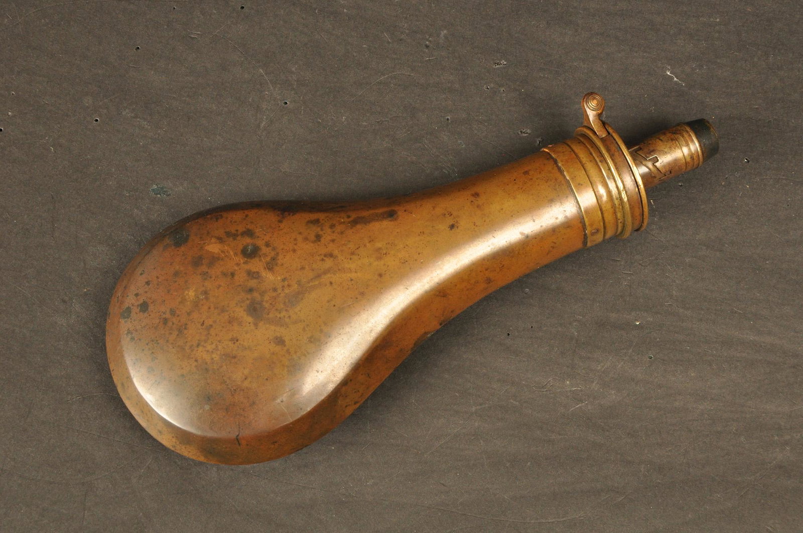 Powder Flask: 19th Century, marked G.J. W Hawksley Sheffield. Copper and brass with a fine mellow finish and in working order. 8" OAL.