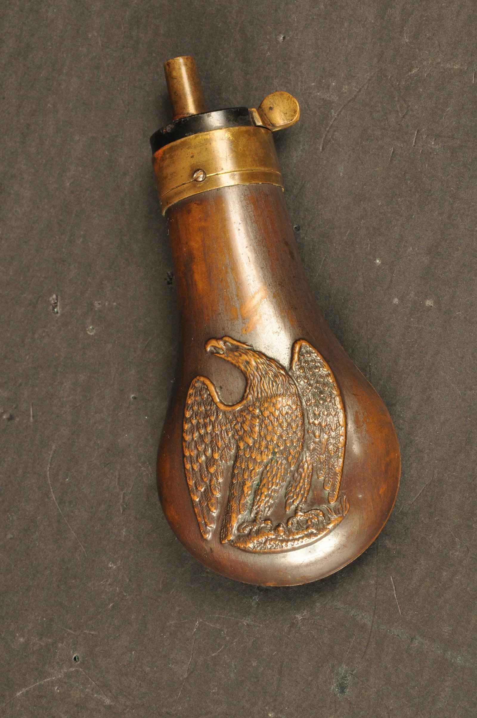 Pistol Powder Flask: Mid-19th Century, unmarked. Copper and brass embossed folded wing American Eagle. Nice patina, working order. 4.5" OAL.