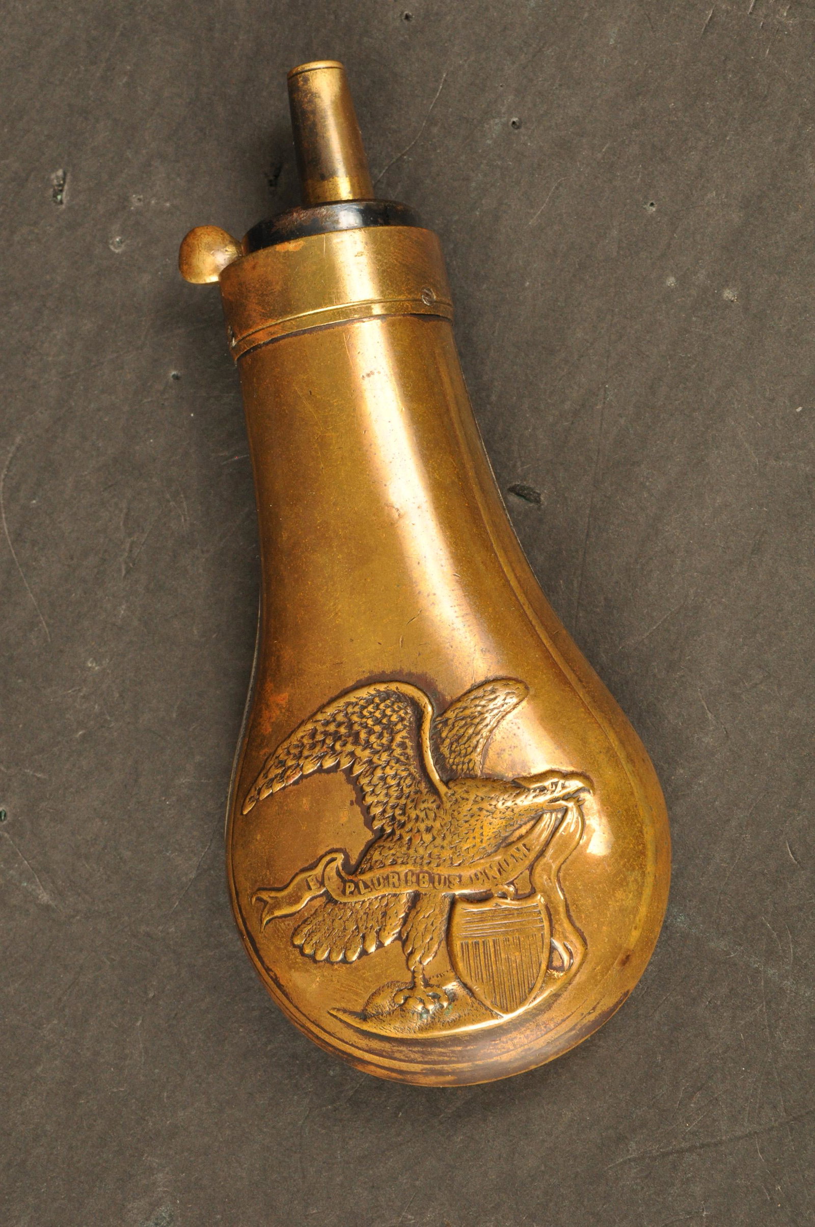 Pistol Powder Flask: Mid. 19th Century. Unmkd. Brass & Copper. Embossed American Eagle on one side w/raised wings, shield, & E. Pluribus Unum banner. Fine patina. 4.5" OAL.