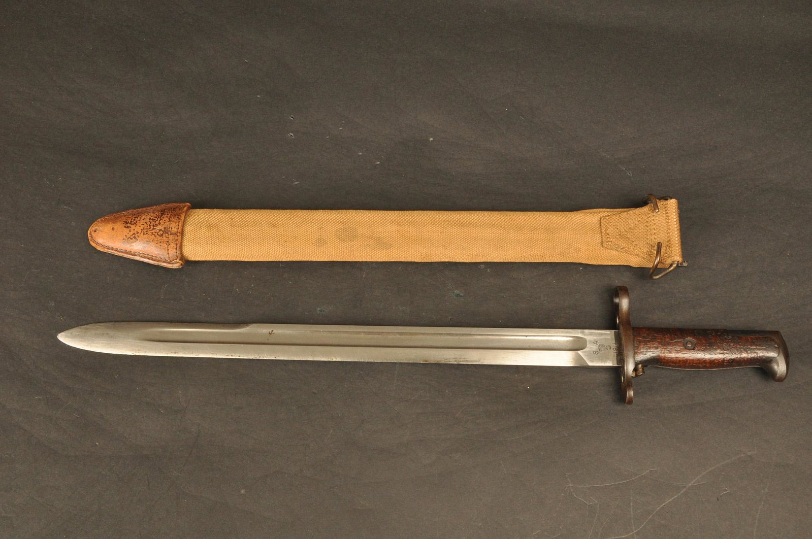 Bayonet: Springfield Armory M1905 w/canvas & leather covered scabbard. Mkd. SA Flaming Bomb & dated 1911. Obverse mkd. # 500080. 16" Blade.